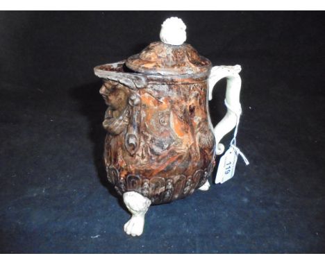 A circa 1770 solid agate ware milk jug and cover, the lip formed as a mask raised on three hairy legs to paw feet CONDITION R