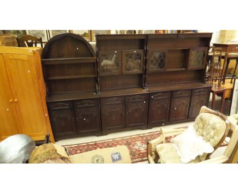 An oak dining suite of furniture comprising D-end extending dining table, a set of six dining chairs, a Dutch style dresser, 