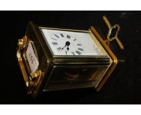 A circa 1900 French lacquered brass cased carriage clock, the enamelled dial with Roman numerals