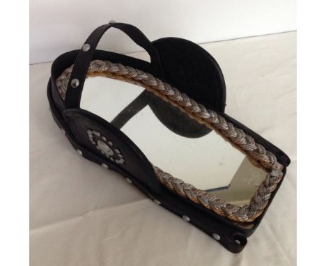 A vintage horse head harness with inset mirror.