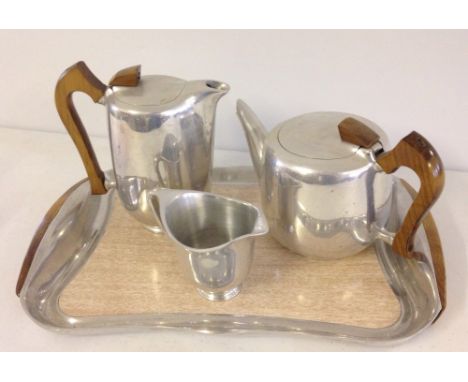 A Picquot stainless steel tea set comprising teapot, hot water jug, and milk jug on a matching tray