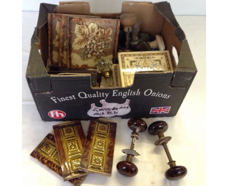 A box of vintage ceramic tiles and door knobs to include Victorian examples.