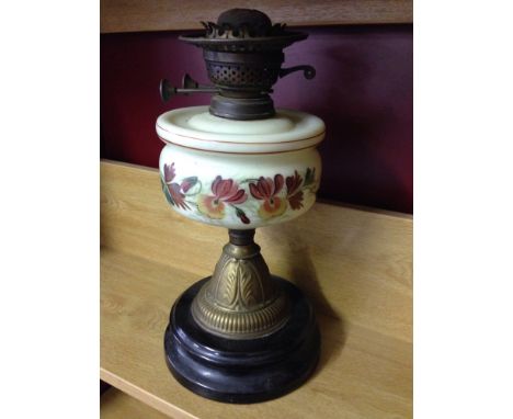 A vintage oil lamp with opaline reservoir decorated with hand painted flowers - no chimney.