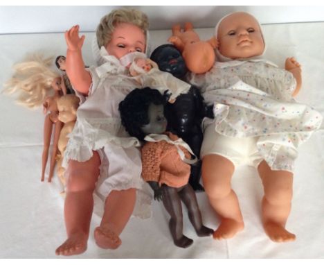 A collection of vintage dolls to include a Pedigree black baby doll.
