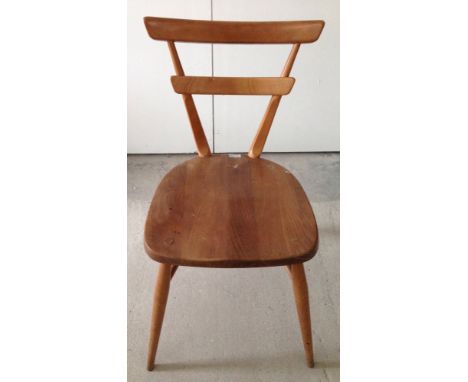 An Ercol green dot stacking chair.