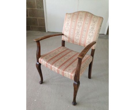 A vintage pink upholstered bedroom chair.