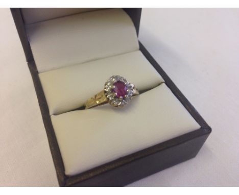 A 9ct gold ruby and diamond cluster style ring, size N.