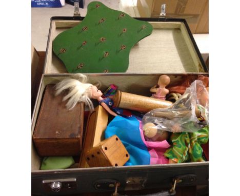 A vintage Globetrotter suitcase containing a quantity of old toys to include wooden chess set (complete), 4 dressed Barbie do