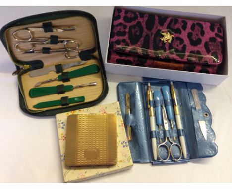 4 vintage ladies items comprising of a boxed goldtone powder compact, 2 cased manicure sets & a new boxed purse.