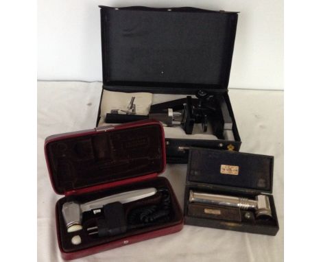 3 cased scientific instruments including microscope.