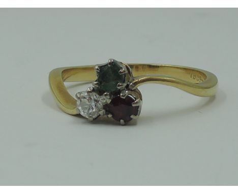 A lady's dress ring having a diamond,emerald and ruby trio, each stone approx 0.125ct in claw set mount to cross over shoulde