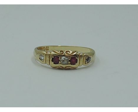 A lady's 18ct gold band ring having rubies and diamonds inset in a moulded mount, size N