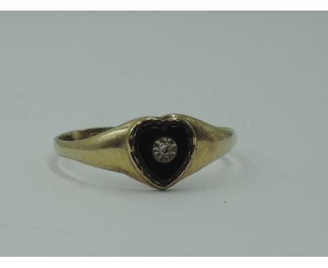 A 9ct gold signet ring having a heart shaped onyx panel with diamond chip inset,  size R &amp; approx 1.4g