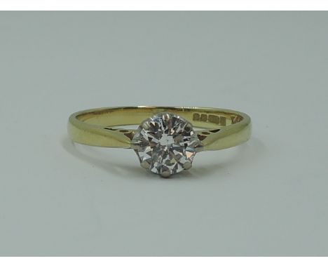 A lady's diamond solitaire dress ring, approx 0.75ct in a claw set mount to raised shoulders on an 18ct gold loop, size P
the