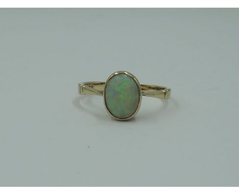 A lady's dress ring having an oval opal in a collared mount on a rose gold loop stamped 9ct,  size I