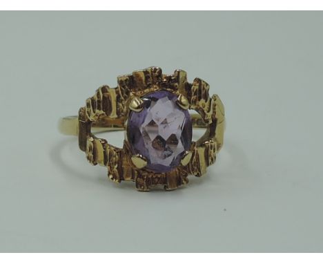 A lady's dress ring having an oval amethyst in a stylised open mount on a 9ct gold loop, size N &amp; approx 3.3g