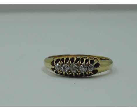 A lady's dress ring having five graduated old cut diamonds in a pierced gallery mount on an 18ct gold loop.  Size K