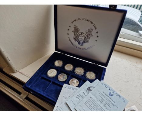 Cased Collection of Seven American USA Silver Dollar Coins