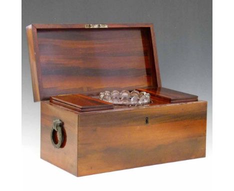 Rosewood tea caddy, 19th century,  with brass wreath loop handles, fitted with two lidded compartments and a central glass mi