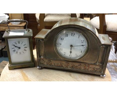 A carriage clock together with one other.