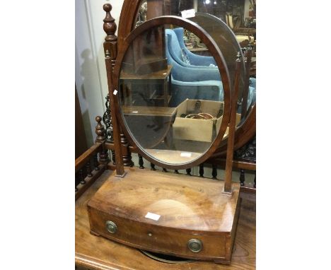 A bow front toilet mirror.