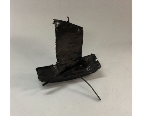 A Chinese silver model of a boat. Marked to side. Approx. 21 grams. Est. £20 - £30.