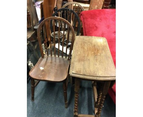 Three stick back chairs together with a drop leaf table.