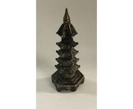 A heavy Chinese silver pepper in the form of a pagoda. Marked to base. Approx. 33 grams. Est. £60 - £80.