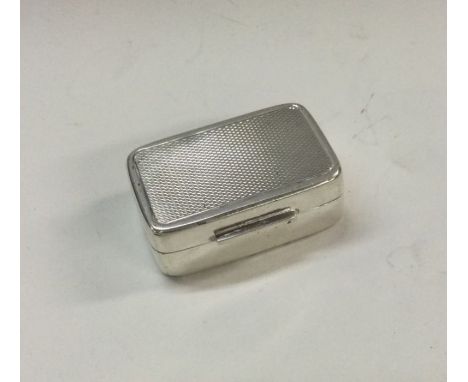 AN engine turned silver hinged box. Approx. 25 grams. Est. £30 - £50.