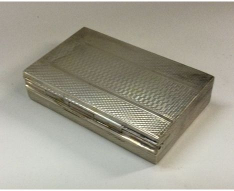 A heavy engine turned silver hinged box. Approx. 56 grams. Est. £40 - £60.