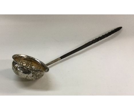 A chased George III silver toddy ladle with whalebone handle. Approx. 39 grams. Est. £30 - £50.