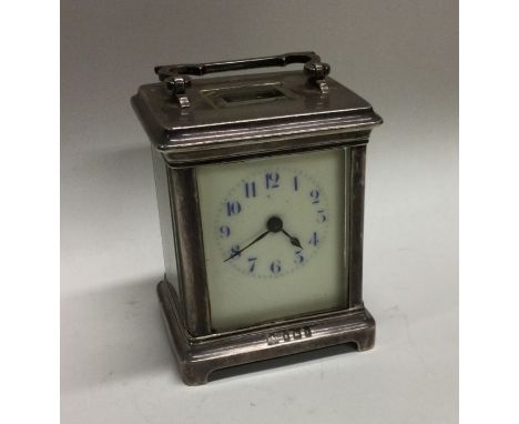 An Edwardian silver carriage clock with white enamelled dial to bracket feet. Birmingham. By Elkington &amp; Co. Approx. 500 