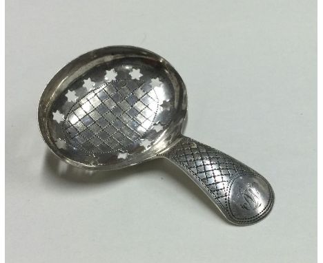 A good Georgian silver bright cut caddy spoon. London. By IT. Approx. 5 grams. Est. £40 - £60.