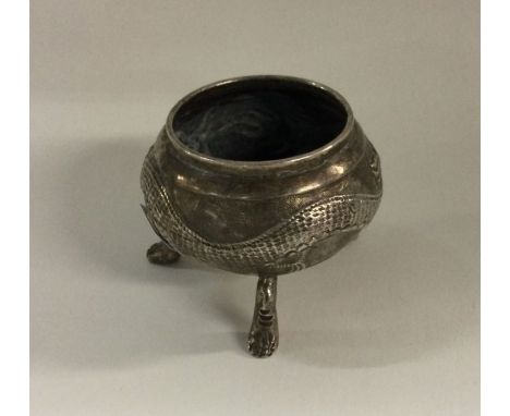 WANG HING: A chased Chinese silver bowl on feet decorated with dragons. Marked to base. Approx. 36 grams. Est. £30 - £60.
