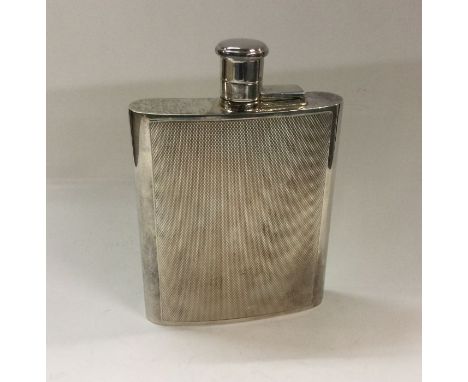 A large engine turned silver flask with screw-on lid. London 1965. Approx. 215 grams. Est. £300 - £400.