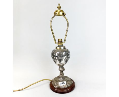 A 19th C silver plated oil lamp base mounted as a table lamp, H. 46cm.