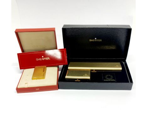 A boxed Dupont gold plated lighter, together with a boxed Shaeffer ballpoint pen set.