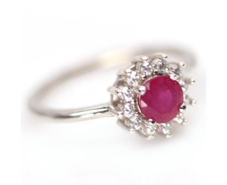 A 925 silver cluster ring set with a rund cut ruby and white stones, (N).