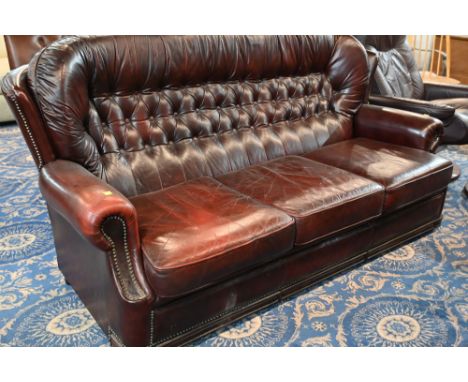 Red leather button back three seater sofa, 180 cm long