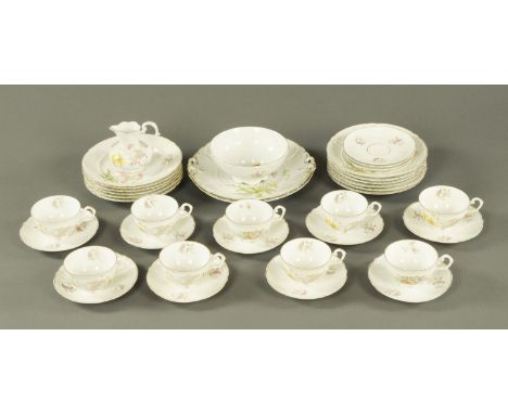 A part tea service, early 20th century, principally 12 place settings (3 cups missing), printed floral decoration and marked 