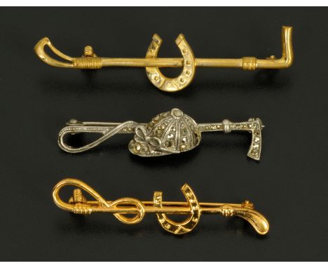 A silver and marcasite jockey cap and whip bar brooch, and two gold plated hunting bar brooches.