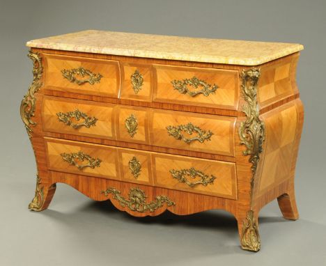 An early 20th century Continental walnut and specimen wood veneered commode, with two short and two long drawers flanked by c