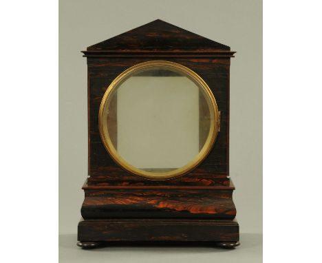 A coromandel veneered bracket clock case, early 19th century, architectural form, with round dial aperture above the moulded 