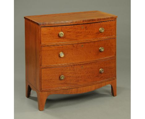 A George III mahogany bowfronted chest of drawers, with three long drawers with brass knob handles, shaped apron and bracket 