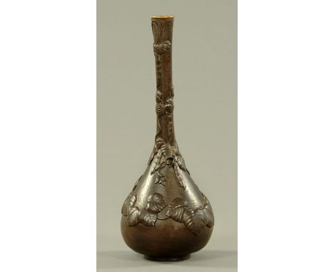 A Japanese cast iron onion shaped vase, Meiji period, applied with kudzu leaves and pods, with bronze patina.  Height 31 cm. 