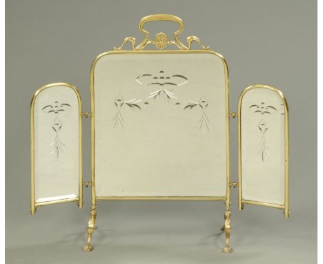 A Victorian brass mirrored fire screen.