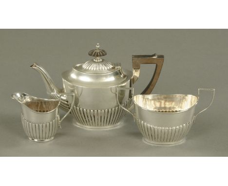 A three piece silver small tea service, matched, comprising half fluted teapot, length 20.3 cm, Sheffield 1904, 302 grams gro