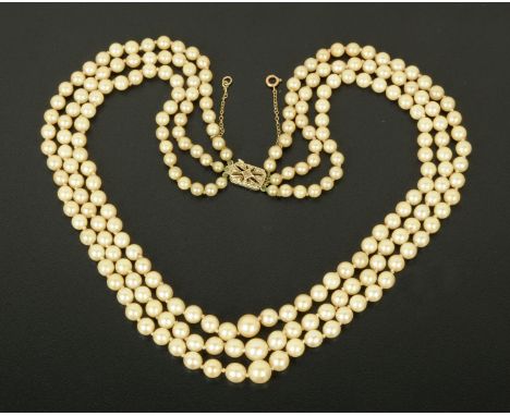 A triple string cultured pearl necklace, with 9 ct gold clasp set with a single diamond.  Length 46 cm (see illustration). 