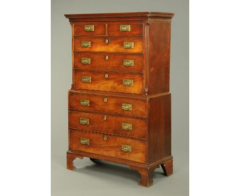 A George III mahogany chest on chest, with moulded dentil cornice above a series of drawers with brass drop handles with rect