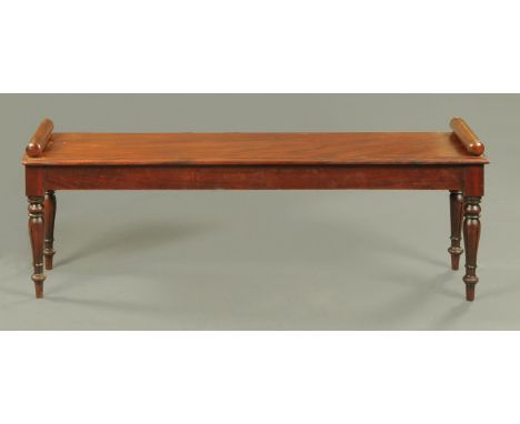 A Victorian style mahogany hall bench or window seat, with bolster ends and raised on turned and fluted legs.  Width 136 cm (